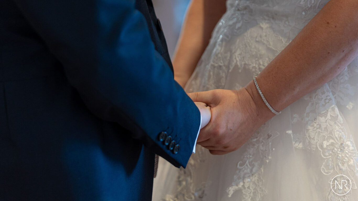 Nathan-Roberts-bride-and-groom-saying-vows-logo